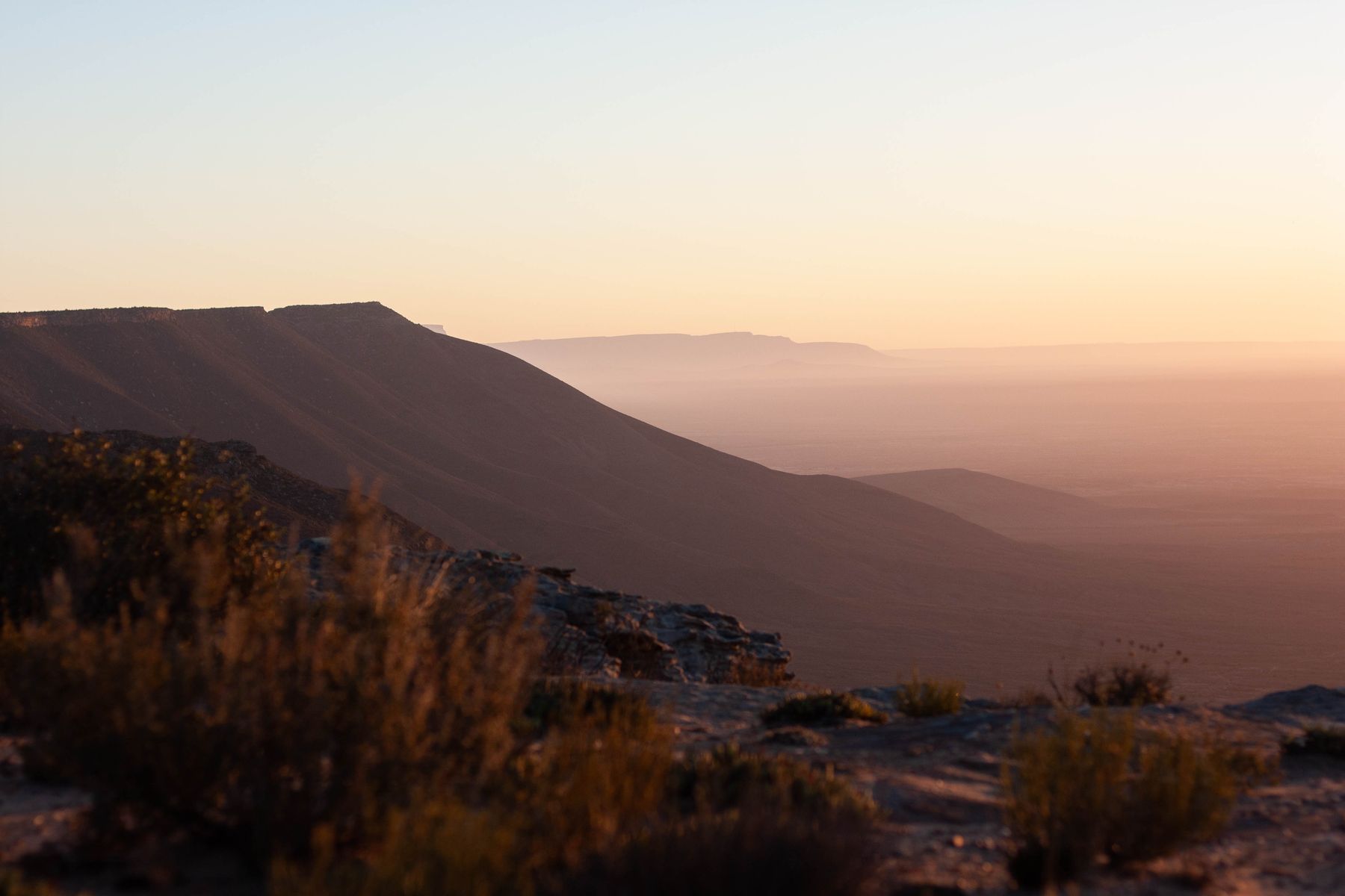 The Bokkeveld escarpment at dusk with a plain fading into haze below